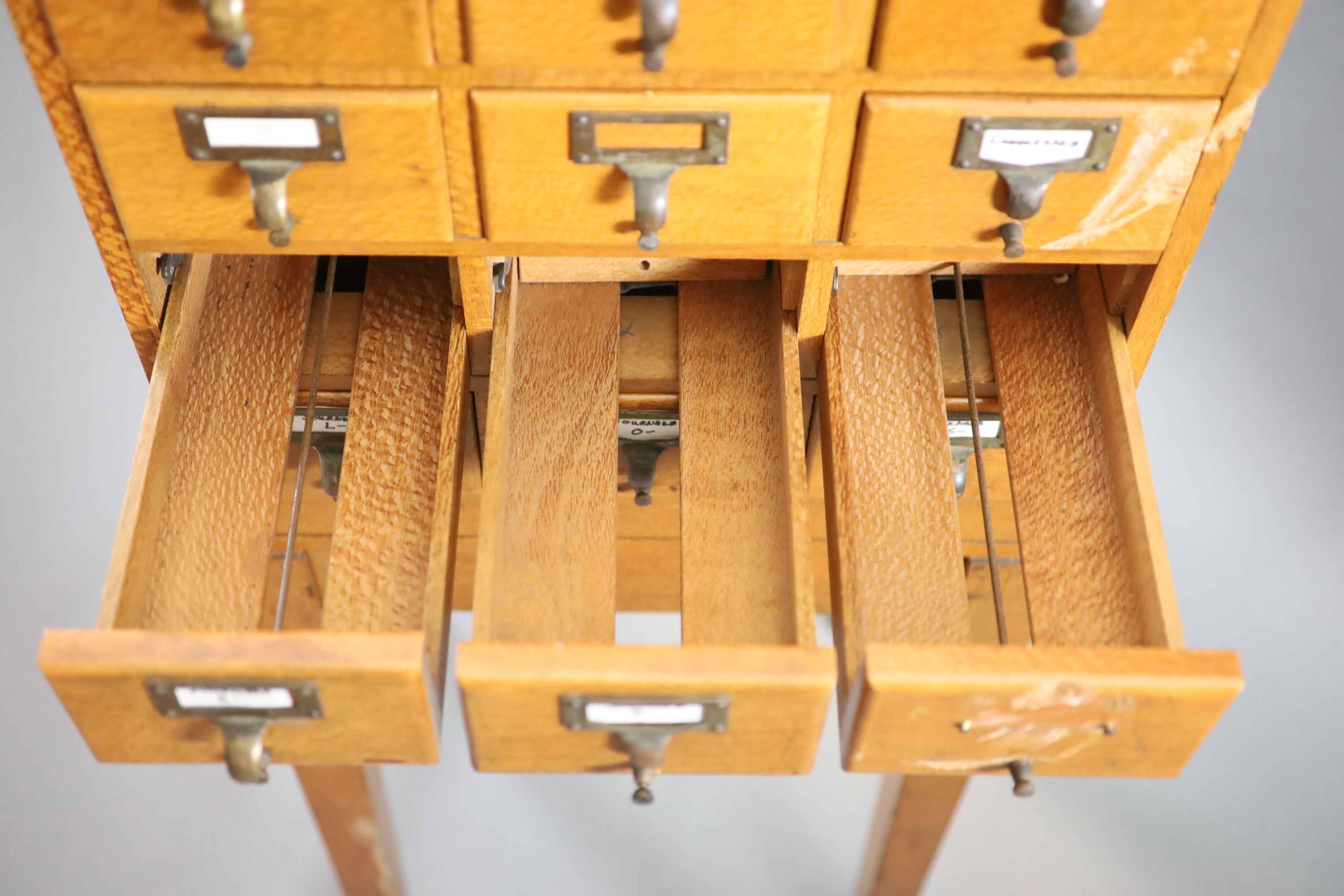 An early 20th century golden oak filing chest on stand, fitted twelve drawers, width 50cm depth 41cm height 131cm